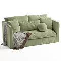 Light Green Fabric Two Seater Sofa With Multiple Cushions And Fringed Blanket