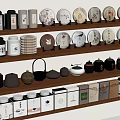 Assorted Tea Collection On Wooden Shelves With Ceramic Pots And Packages