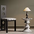 Modern Black Frame Chair With Circular Cutouts And White Marble Table Lamp