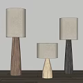 Minimalist Floor Lamps With Wooden Bases And Cream Lamp Shades On Wooden Floor