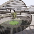 Modern Office Building With Curved Glass Facade Central Courtyard Green Lawn And Tree