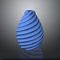 Green Leafy Plant in Blue Spiral Vase on Dark Reflective Surface