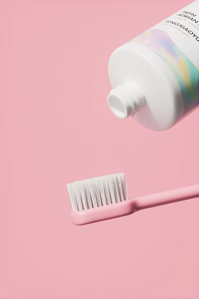 Pink Toothbrush With White Bristles And Toothpaste Bottle On Pink Background 3d model
