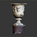 Intricately Carved Vase Shaped Sculpture Featuring Relief Figures On Red Base