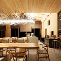 Modern Restaurant Interior With Wooden Ceiling Chandelier Open Layout Dining Table And Bar Counter