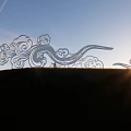 Cloud Shaped Garden Ornaments Under Blue Sky With Sunset And Mountains