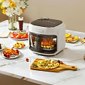 Multifunctional Air Fryer On Kitchen Countertop With Pizza Fried Chicken Fruits And Desserts
