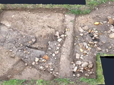 Archaeological Excavation Site With Exposed Soil Stones And Grass Edges 3d model