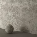 Neutral Toned Textured Wall Component Featuring Rough Surface And Decorative Sphere