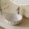 Scalloped White Washbasin on Light Countertop with Vase and Round Mirror