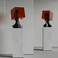 Modern Abstract Black Sculpture With Red Cube Design On Gray Concrete Pedestal