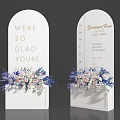 Floral Display with White Archway Welcome Text and Blue White Flowers for Hotel Event