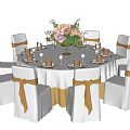 Banquet Hall Setup With Round White Tablecloth Flower Bouquet And Gold Ribbon Chairs