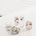 Elegant Table Setting With Glass Cups Rosemary Water Candle And Macarons On White Table
