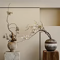 Ceramic And Striped Vases With White Blooms On Stone And Wooden Bases Against Neutral Wall
