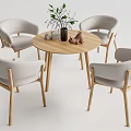 Modern Round Wooden Dining Table Set with Four Light Gray Upholstered Chairs Vase Plants Decor