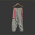 Gray Sports Pants With Red Side Stripes Hanging On Wooden Hanger For Daily Wear