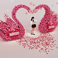 Girl Standing Under Pink Swan Balloon Arch With Heart Decorations And Petals
