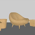 Wicker Leisure Chair With Matching Side Tables On Wooden Floor And Neutral Wall