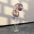 Decorative Floral Installation With Large Flowers Metallic Stems Leaves White Base Light Shadow Background