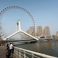 Ferris Wheel Structure Featuring White Support And Blue Water Base Design