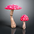 Large and Small Red Mushrooms with White Spots and Brown Stems on Black Background