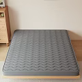 Comfortable Gray Mattress With Wavy Texture On Wooden Bed Frame In Simple Bedroom