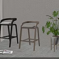Black and Light Wood Bar Stools with Green Plant and Open Magazine on Carpet