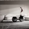 Modern White Curved Sofa and Black Metal Round Coffee Table Set With Decorative Sculpture On Carpet