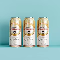 Three Corona Cerveza Golden Beer Cans 270ml on Light Blue Background