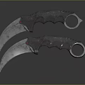 Two Metal Karambit Knives With Curved Blades And Finger Hole Handles