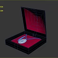 Open Black Jewelry Box With Red Velvet Interior Holding Silver Necklace And Pendant