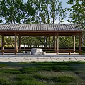 Ancient Architectural Pavilion With Wooden Structure Tiled Roof Stone Table Stools Benches Surrounded By Trees