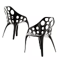 Two Modern Black Leisure Chairs with Circular Cutouts and Stylish Leg Design