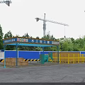 Construction Site Vehicle Washing Shed with Blue Roof Yellow Railings Wooden Crates and Tower Cranes
