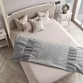 Minimalist Double Bed With Woven Headboard Bedside Tables Table Lamps Decorative Pillows And Striped Blanket