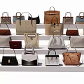 Various Stylish Handbags In Different Colors Neatly Arranged On White Shelves