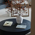 Black Textured Coffee Table With White Vase Books Glass Cup And Dried Twigs