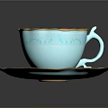Light Blue Teacup and Saucer with Gold Floral Patterns Holding Latte with Swirl Art