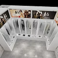 Modern Clothing Store Interior With White Display Cabinets Hanging Clothes And Shoes