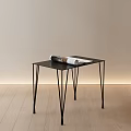 Modern Black Side Table With Slim Legs And Magazine On Light Wall Wooden Floor