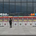 Colorful Outdoor Amusement Equipment With Multiple Claw Machines And Person Standing Near Building