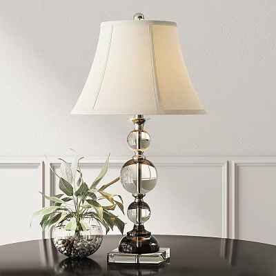 Ivory Lampshade Table Lamp with Glass Globe Base and Green Plant against White Wall Paneling 3d model