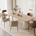 Modern Light Wood Dining Table Set With Beige And Brown Chairs Plants Books And Decorations