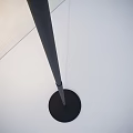 Modern Outdoor Light Featuring Black Slender Cylindrical Lamp Post And Round Base On White Ground