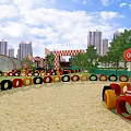 Fun Playground Featuring Colorful Tire Obstacles Sand Ground GO Sign And City Skyline