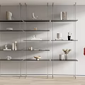 Modern Minimalist Interior Featuring Multi Tiered Shelving Unit With Books Decorative Vases And Sculptures