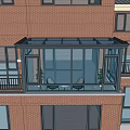 Glass Sunroom Attached To Red Brick Building With Black Frame And Glass Windows