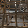 Wooden Grid Cylindrical Art Installation with Light Shadow Effects in Indoor Space and Figure Inside