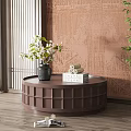 Round Brown Lattice Design Coffee Table With Vase Books And Green Plants On Wooden Floor